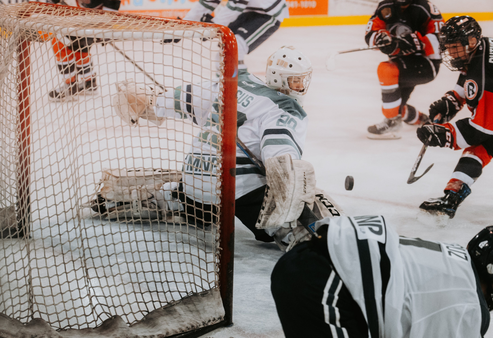 Goalie making a save in front of the net